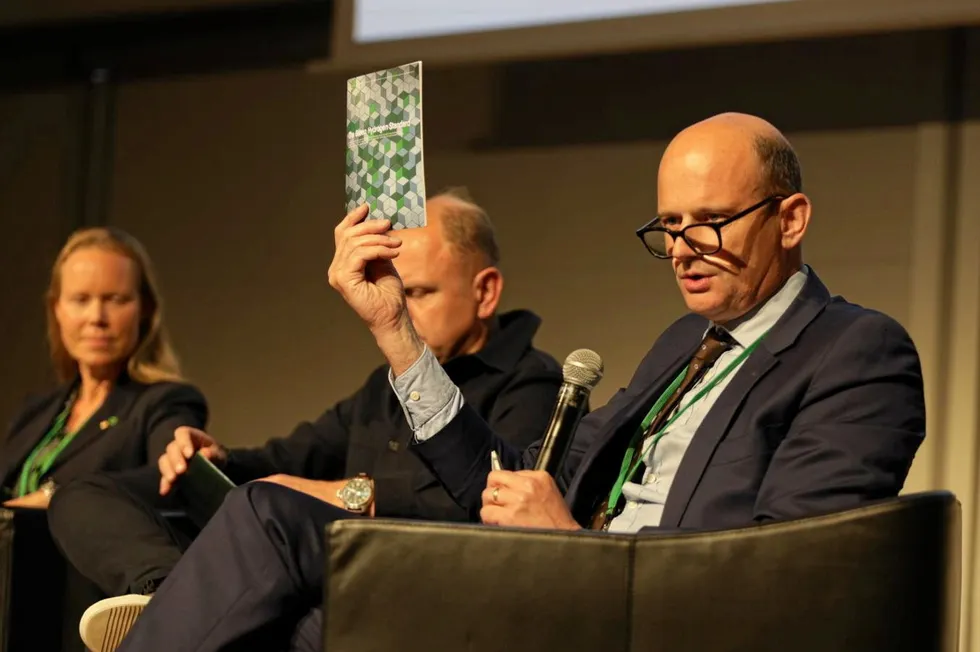 Jonas Moberg, CEO of the Green Hydrogen Organisation, holding up a printed copy of the current Green Hydrogen Standard.