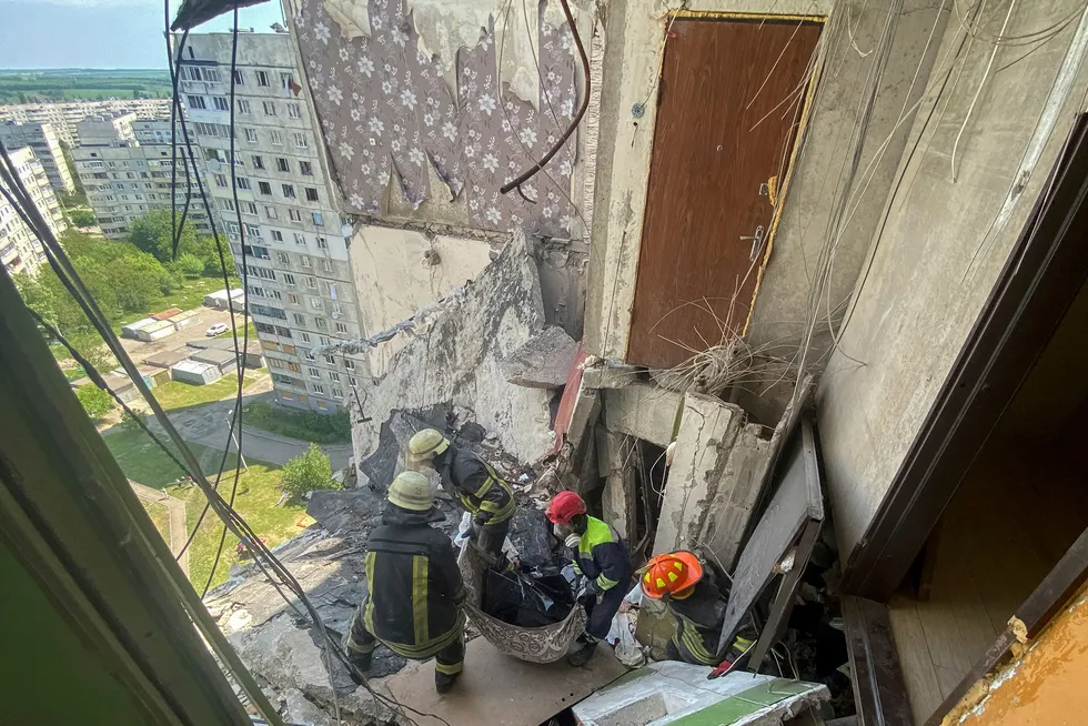 Broken: rescuers carry the body of civilian from a residential building damaged by shelling of Kharkiv in Ukraine