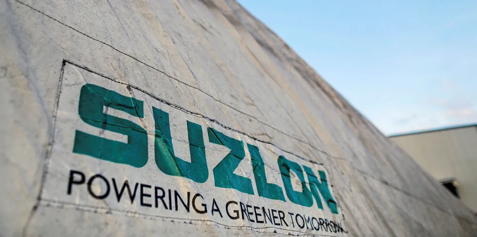 The Suzlon Energy Ltd. logo is displayed on a wind turbine blade cover at the company's rotor blade manufacturing plant in Bhuj, India.