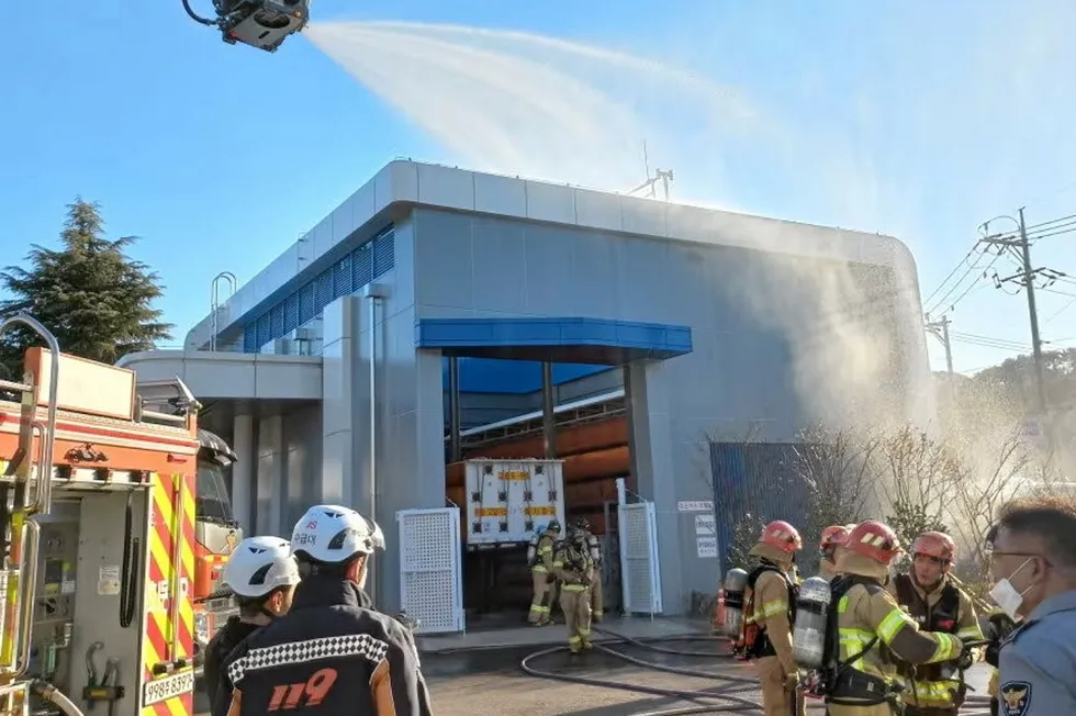 Firefighters outside the machine room at the Busan hydrogen refuelling station following the fire and explosion on 27 December. The pumps are out of shot, behind the fire engine on the left.