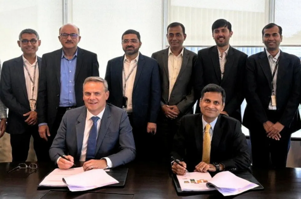 Ceres CEO Phil Caldwell (front, left) and Thermax managing director and CEO Ashish Bhandari (front, right) sign the licensing agreement.