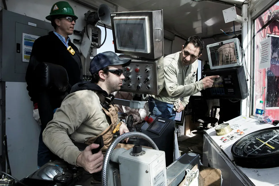 Håkon Skjelvik (med hjelm) fra norske Tomax inne i kontrollrommet på en landrigg i Midland i Texas. Her sammen med Raul Reza (til høyre), sjef for borevirksomheten på en borerigg fra Sidewinder Drilling.