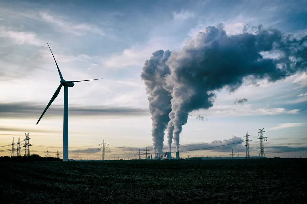 A wind turbine near a coal-fired power plant in Germany.