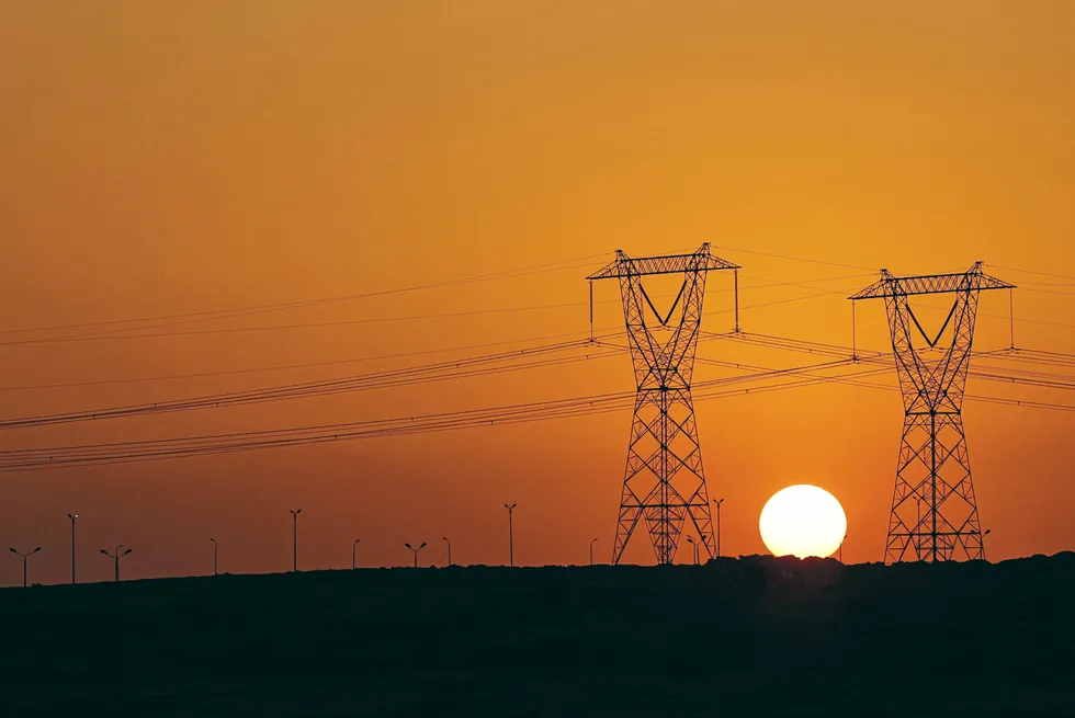 High voltage transmission towers (electricity pylons) along a highway in El-Shorouk, Egypt.