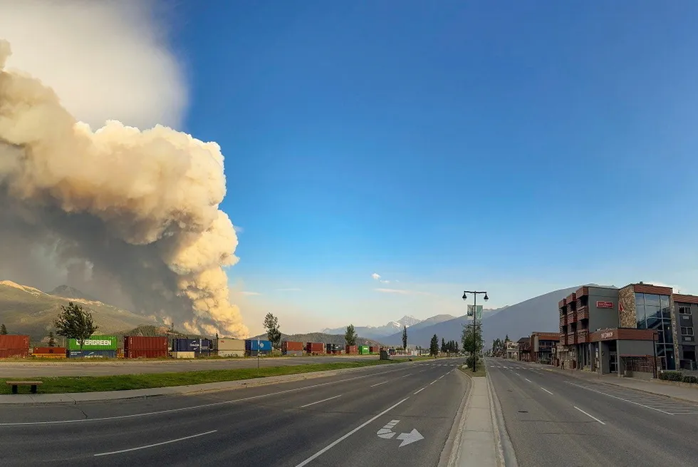 In this photo released by the Jasper National Park, smoke rises from a wildfire burning near Jasper, Alberta, Canada, on Wednesday, 24 July 2024.