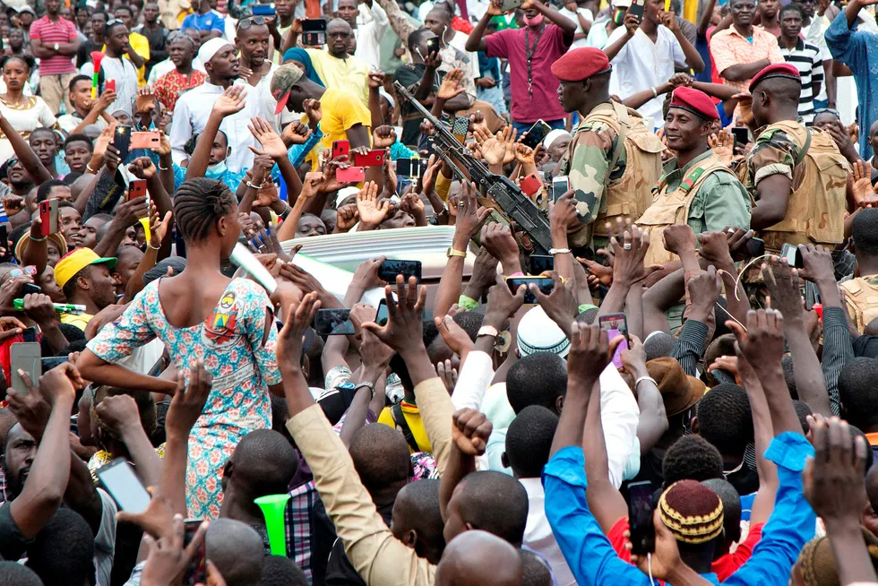 Bloodless coup: Malian army soldiers arrive amid a crowd of supporters in Bamako's Independence Square after the overthrow of the country's president