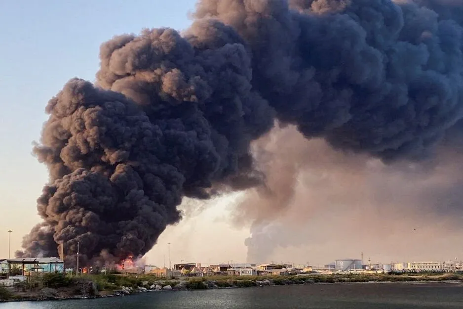 A large plume of smoke rising from a fuel depot in Port Sudan, Sudan.