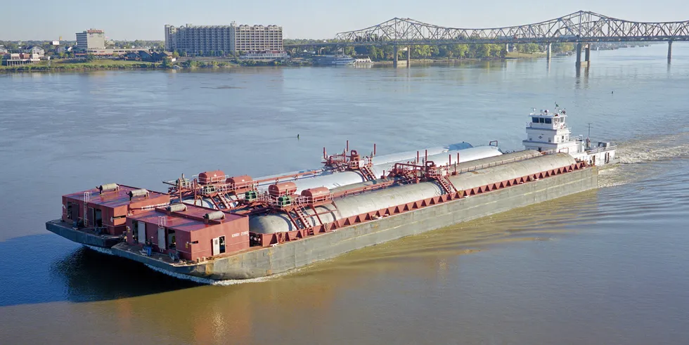 A towboat pushes two ammonia tanker barges along the Ohio River on the border between the US states of Kentucky and Indiana.