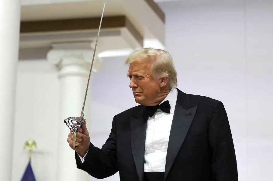 US President, Donald Trump, holds a sword during the Commander in Chief Ball in honour of his inauguration in Washington, DC, on 20 January 2025.