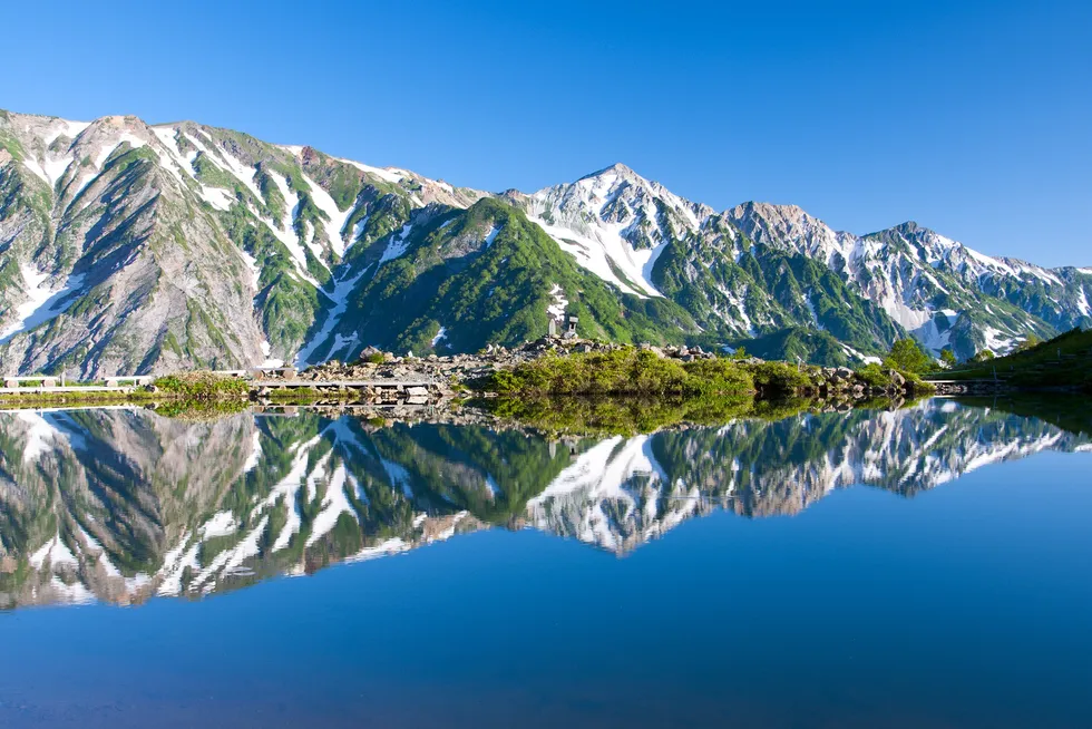 The Happo Onsen pond at Hakuba hot springs in Japan, surrounded by serpentine rocks