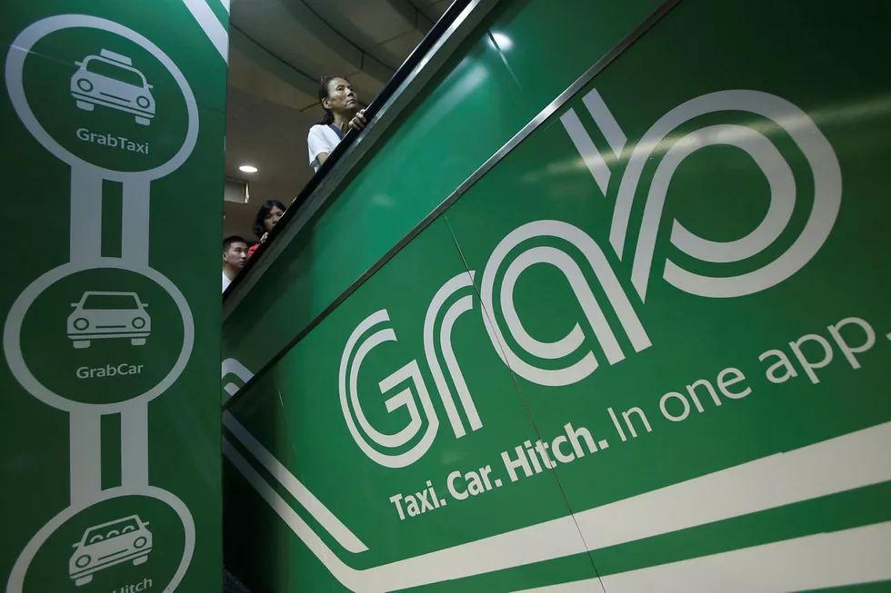 Kjøretjenesten Grab overtar Ubers virksomhet i Sørøst-Asia. Foto: Edgar Su/Reuters/NTB Scanpix