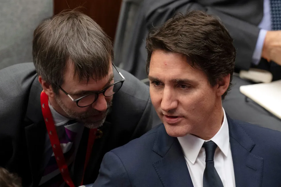 Canada Prime Minister Justin Trudeau (right) speaks with Minister of Environment & Climate Change Steven Guilbeault.