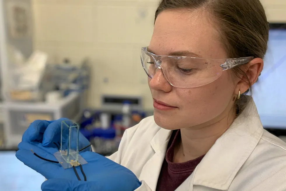 Nanophysicist Yemima Ehrnst holding the acoustic device used to boost hydrogen output.