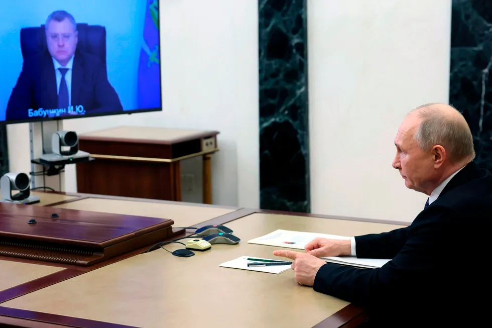 Russian President Vladimir Putin (right) sits at a videoconference meeting with Astrakhan regional governor Babushkin in the Kremlin in Moscow, Russia, Monday, in April 2024