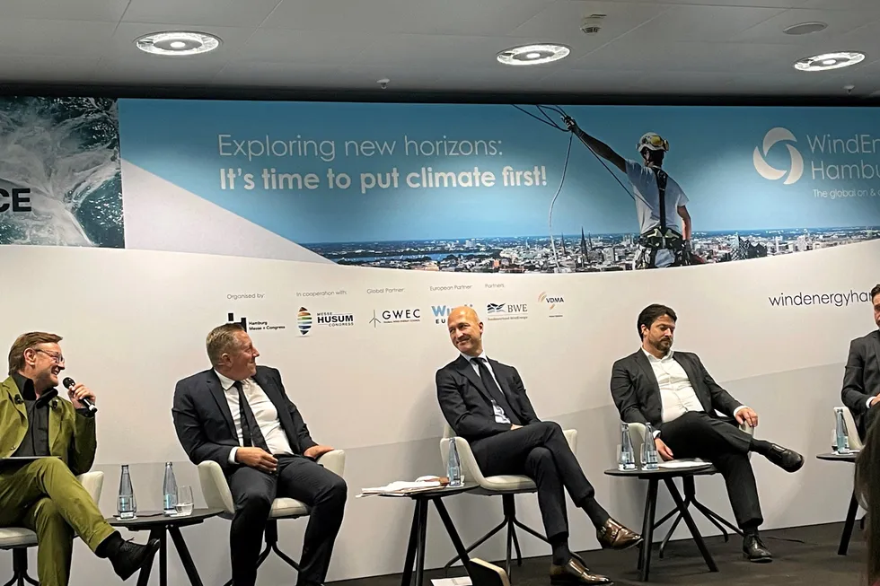 Sven Utermöhlen, left, talks at the WindEnergy Hamburg panel.