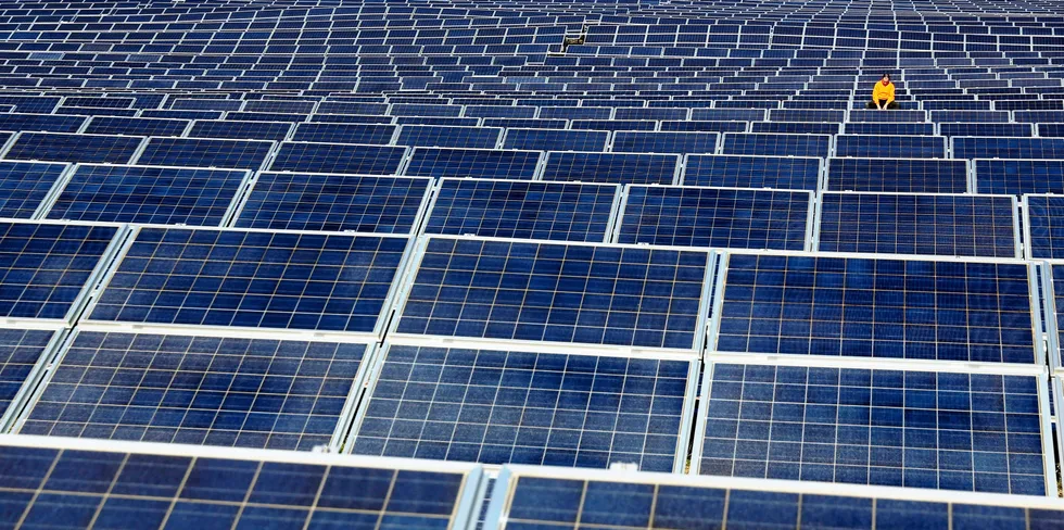 A maintenance man works on solar panels at an array in northern Spain.