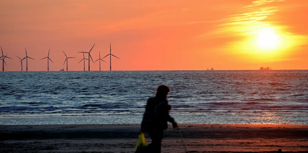 The sun sets over the Burbo Bank wind farm in the Irish Sea viewed from New Brighton, north west England.