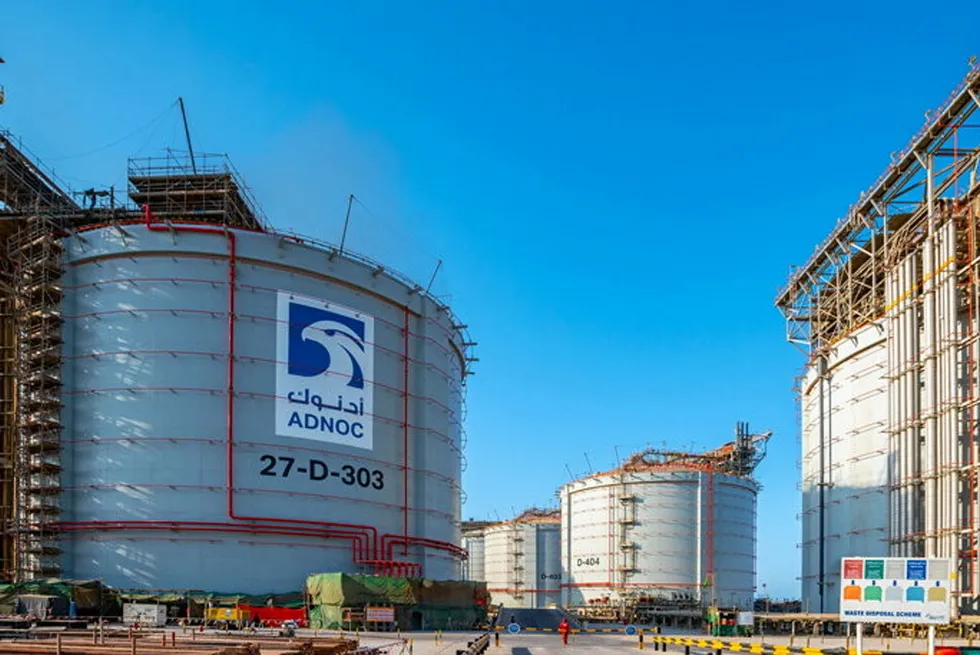 A gas storage tank emblazoned with an Adnoc logo.