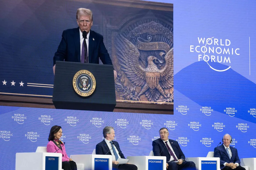 TotalEnergies chief executive Patrick Pouyanne (second right) asks a question to US President Donald Trump (on screen) during Trump's address by video conference at the World Economic Forum in Switzerland in January 2025.