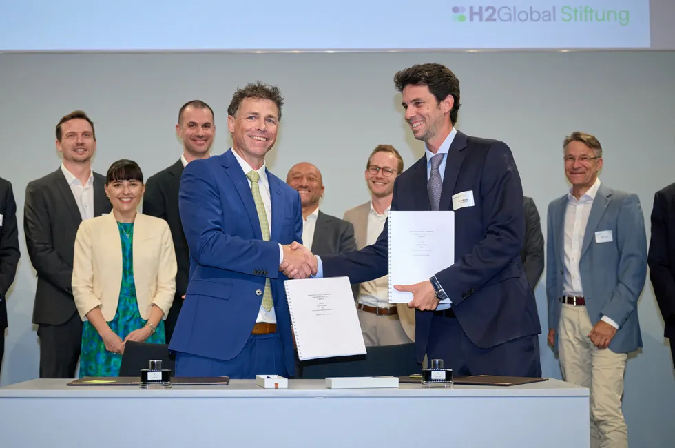 Hintco CEO Timo Bollerhey shakes hands with Fertiglobe head of investments and projects, Tarek Hosny, after signing H2Global's first Hydrogen Purchase Agreement last year.