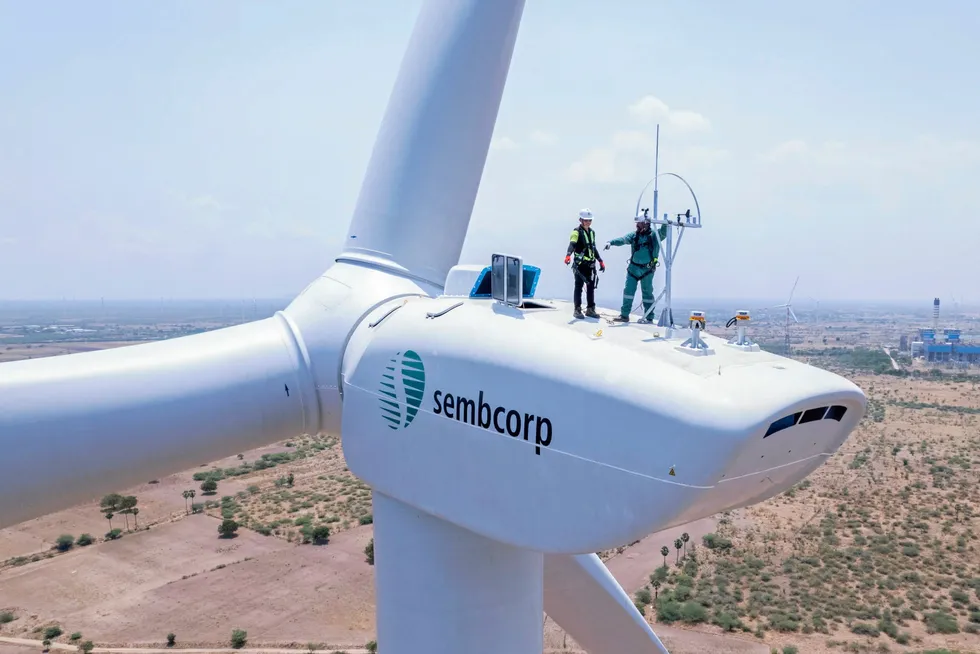 A wind turbine branded with Sembcorp's logo.