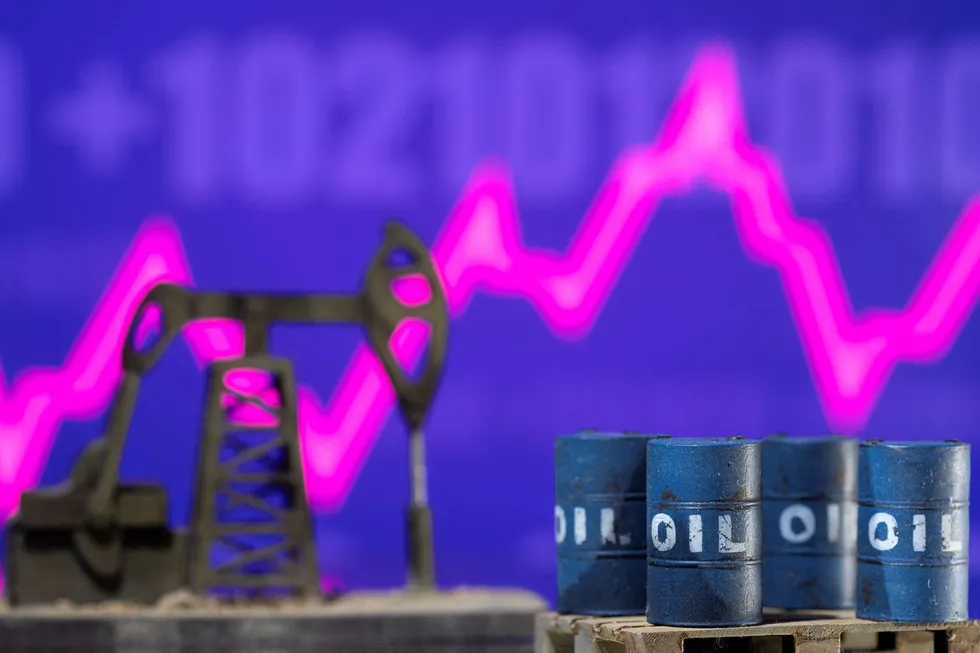 Models of oil barrels and a pump jack are displayed in front of a rising stock graph.