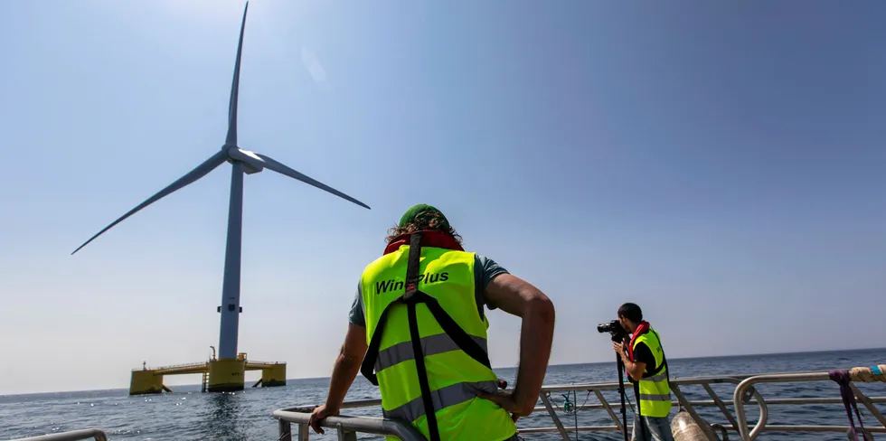 Cameramen are seen taking images of the Windfloat Atlantic in northern Portugal.