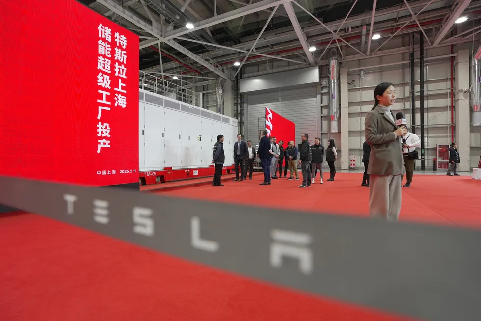 A journalist covers a ceremony marking the production launch of Tesla's Megapack energy storage plant in February.