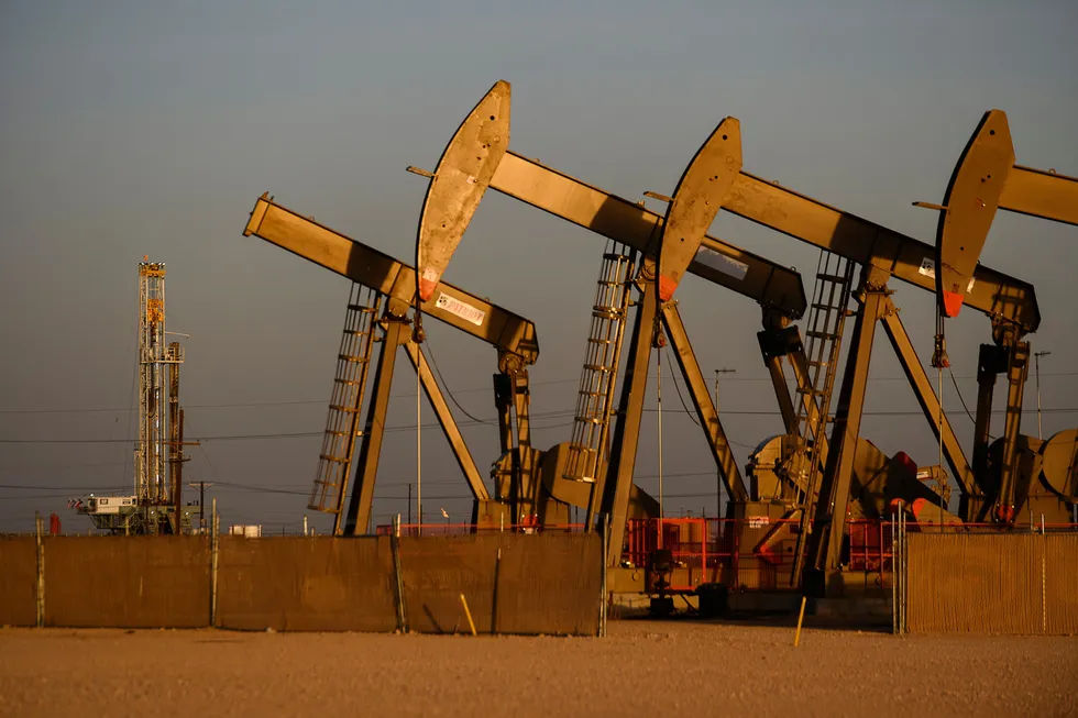 An array of pumpjacks operating oil and gas wells.