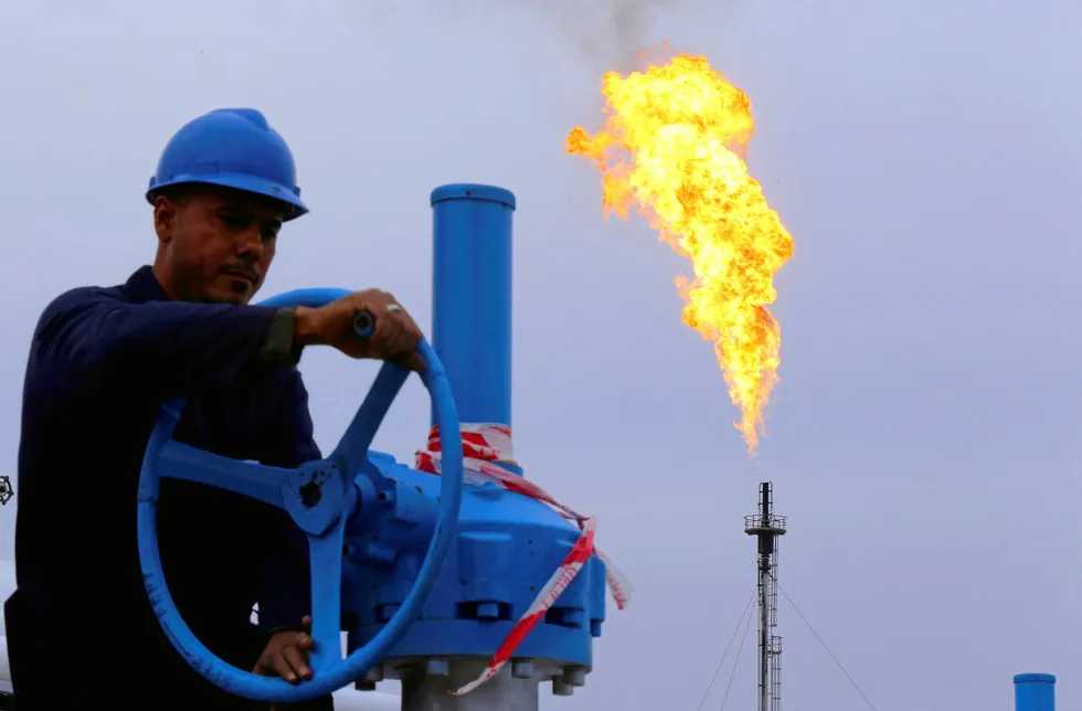 Operations: a worker adjusts the valve of an oil pipe at the Khurmala oilfield on the outskirts of Arbil, in Iraq's Kurdistan region