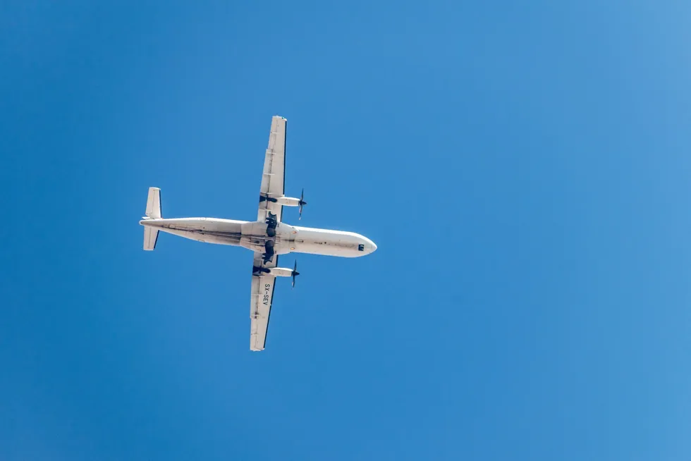 A turbo-prop plane flying over northern Greece.