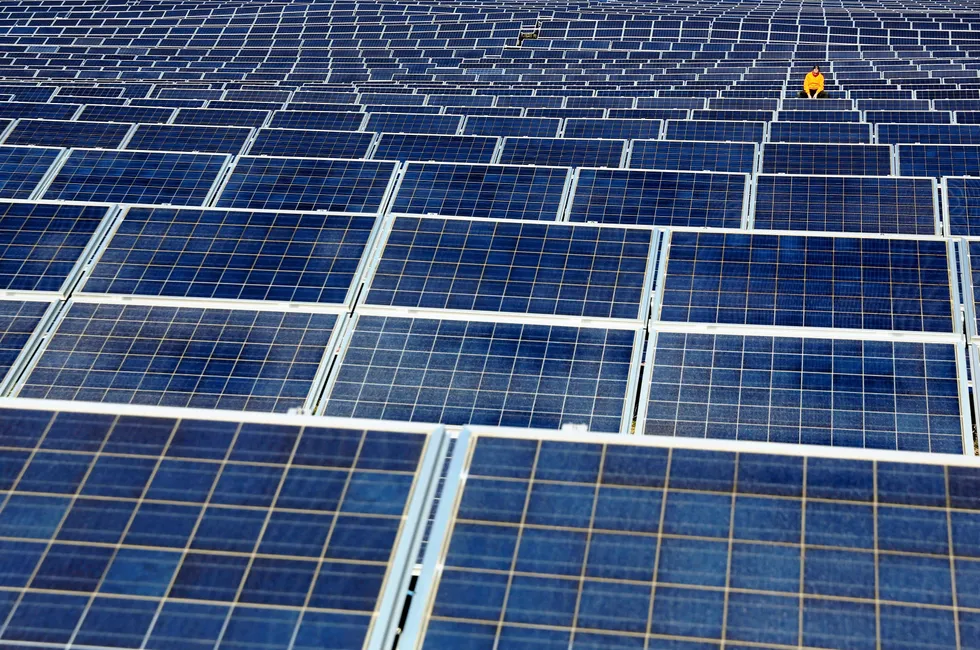 A maintenance man works on crystalline-silicon solar panels at an array in northern Spain.