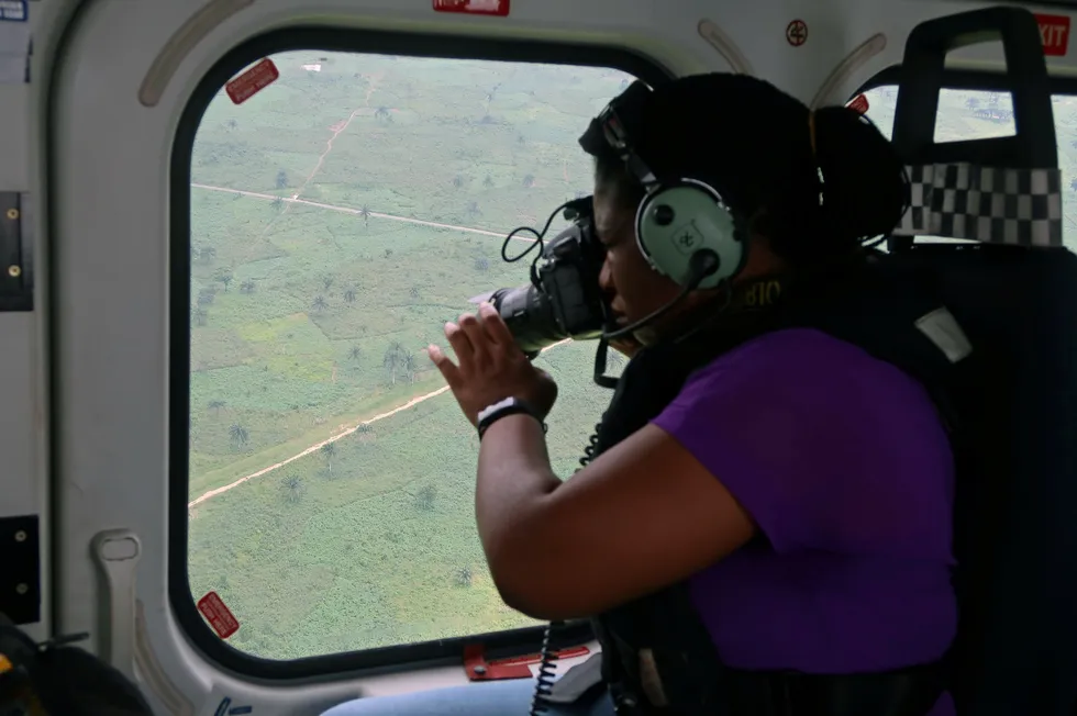 A photographer takes pictures of the Trans-Niger pipeline in the Niger delta in 2018