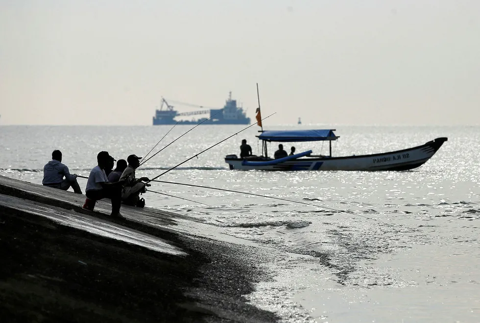 Growing economy: people fishing in Cilacap, Central Java, Indonesia