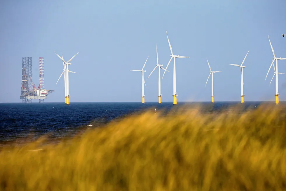 Closer ties: a jack-up drilling rig stands close to wind turbines off the UK