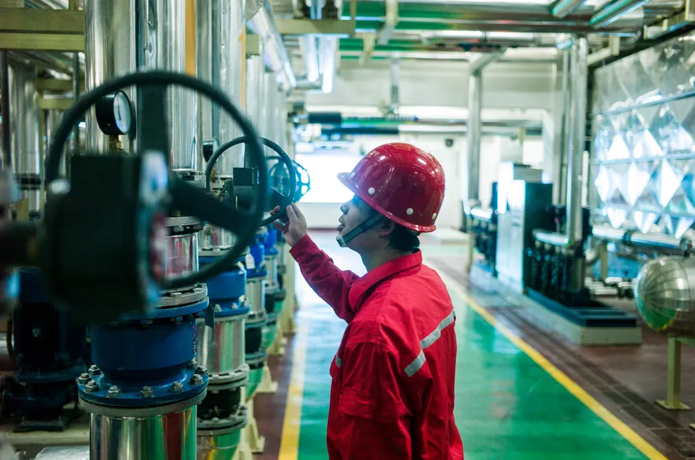 A Sinopec worker operating a geothermal heat pump in Heibei province, China.