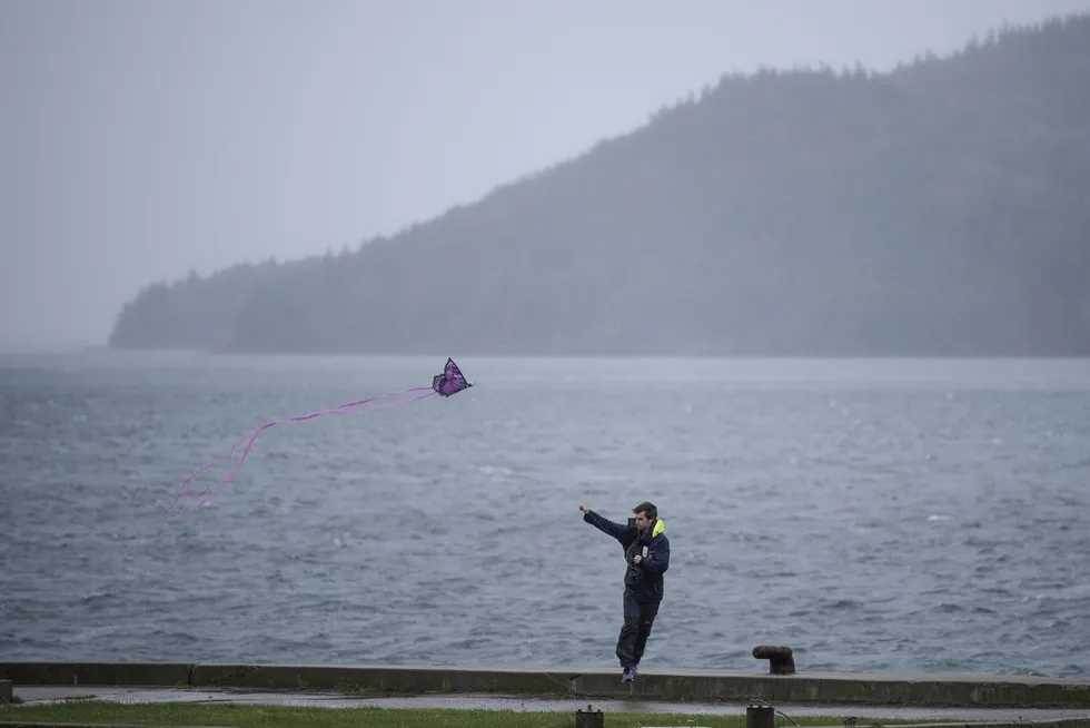 Windy province: a man flies a kite along Canso Causeway in Nova Scotia, Canada as wind and rain from Storm Fiona hit the region.