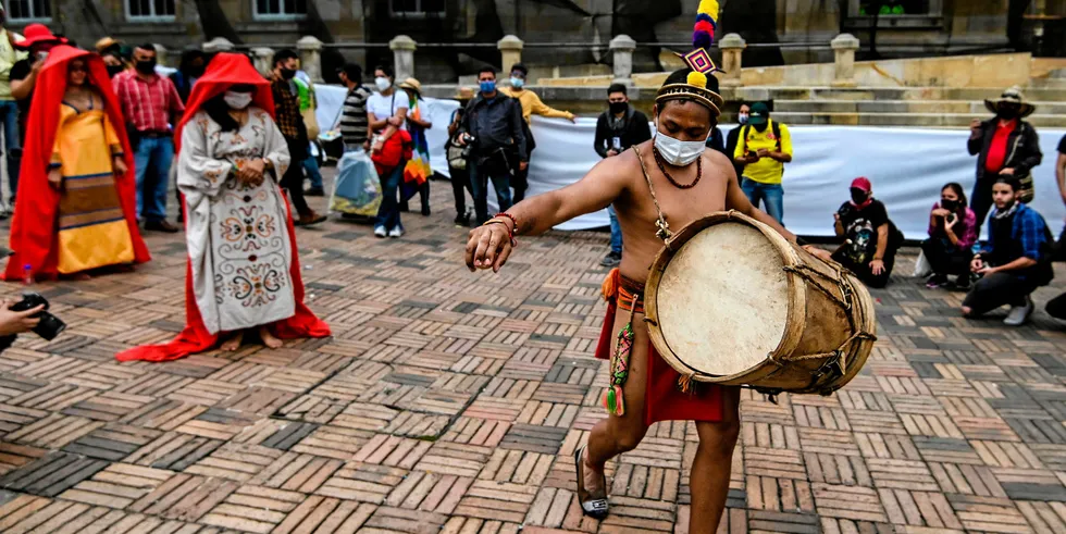 Members of the Wayuu ethnic group perform during a protest in Bogota.