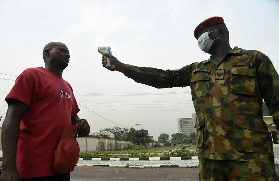 Taking the temperature: Soldiers in Lagos, Nigeria, try to help track a disease which has affected the region's oil industry