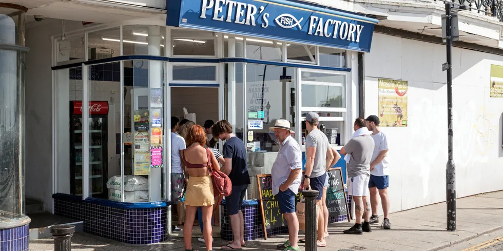 A queue of people outside Peter's Fish Factory in Margate, Kent, UK.