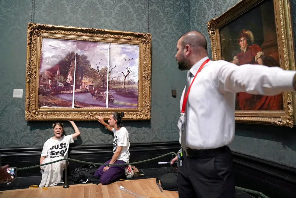 Performance art: a security guard looks at protesters who glued their hands to the frame of John Constable’s The Hay Wain, inside the National Gallery in London on 4 July