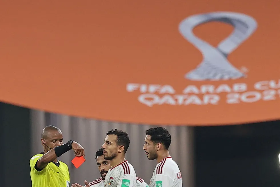 Qatar carnival: UAE's players try to avoid a red card for their teammate during their FIFA Arab Cup match against Syria