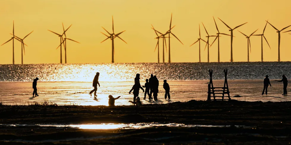Skaters at Bunkeflostrand, south of the Oresund Bridge in southern Sweden, with Lillgrund offshore wind farm in the background