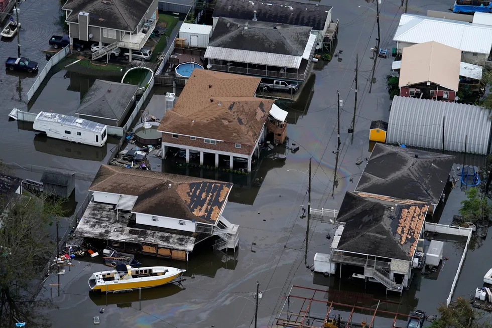 Inundated: an oil slick drifts between damaged homes in the aftermath of Hurricane Ida in Lafitte, Louisianna last week