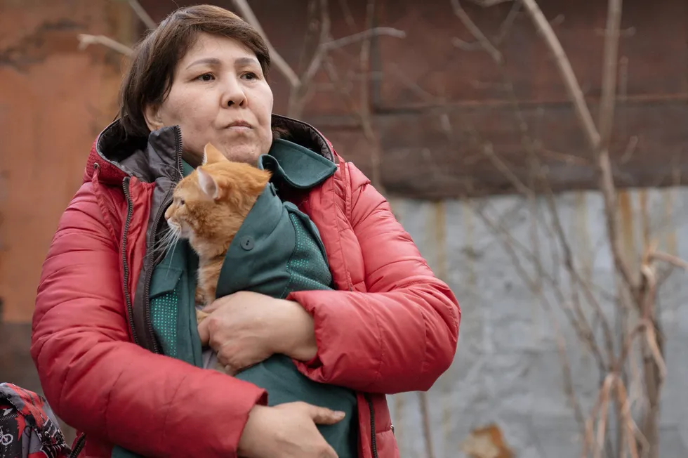 A woman holds a cat during the evacuation of a flooded residential area in Petropavl, Kazakhstan.