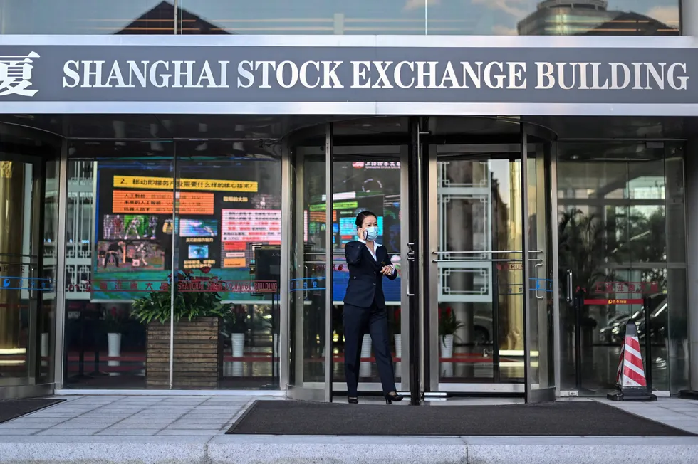 Seeking IPO: a woman leaves the Shanghai Stock Exchange building in Shanghai, where Sinochem Energy will seek a flotation