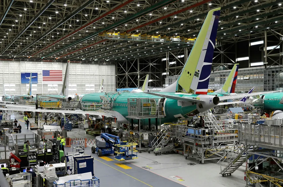 FILE - In this March 27, 2019, file photo people work on the Boeing 737 MAX 8 assembly line during a brief media tour in Boeing's 737 assembly facility in Renton, Wash. On Wednesday, May 1, the Institute for Supply Management, a trade group of purchasing managers, issues its index of manufacturing activity for April. (AP Photo/Ted S. Warren, File)