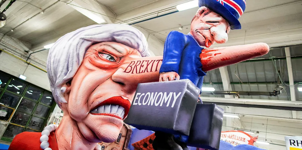 Prime Minister Theresa May is depicted with a Pinocchio nose reading "Brexit" piercing the British economy on a carnival float in the Rose Monday carnival street parade in Duesseldorf, western Germany.