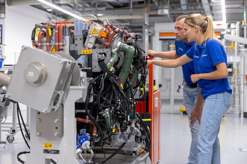 Bosch workers examine one of the company's fuel-cell power modules for commercial vehicles at its factory in Stuttgart, Germany.