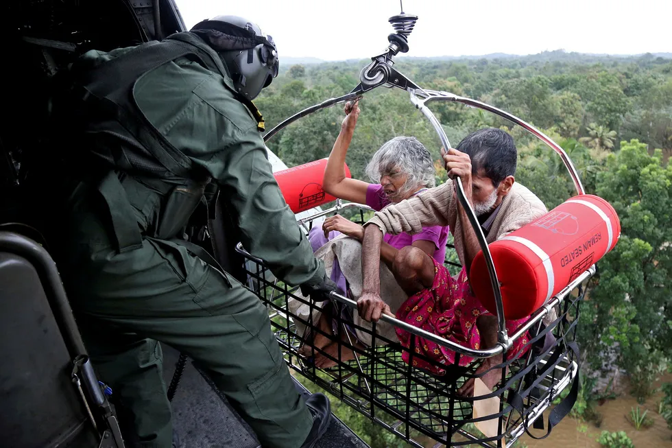 People are airlifted by the Indian Navy soldiers during a rescue operation at a flooded area in the southern state of Kerala, India, August 17, 2018. REUTERS/Sivaram V TPX IMAGES OF THE DAY ---